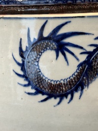 A pair of Chinese blue, white and copper-red 'dragon' fish bowls, Qianlong