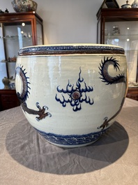 A pair of Chinese blue, white and copper-red 'dragon' fish bowls, Qianlong