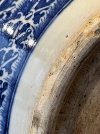 A pair of Chinese blue, white and copper-red 'dragon' fish bowls, Qianlong