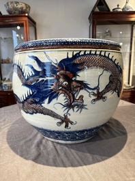 A pair of Chinese blue, white and copper-red 'dragon' fish bowls, Qianlong