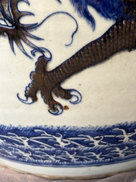 A pair of Chinese blue, white and copper-red 'dragon' fish bowls, Qianlong