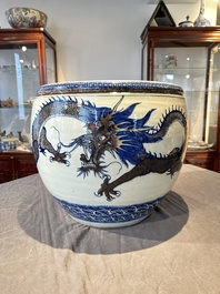 A pair of Chinese blue, white and copper-red 'dragon' fish bowls, Qianlong