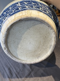 A pair of Chinese blue, white and copper-red 'dragon' fish bowls, Qianlong