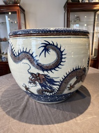 A pair of Chinese blue, white and copper-red 'dragon' fish bowls, Qianlong