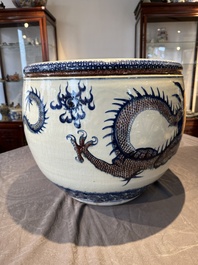 A pair of Chinese blue, white and copper-red 'dragon' fish bowls, Qianlong