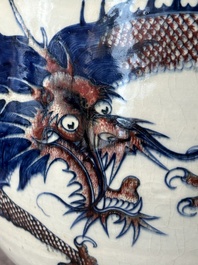 A pair of Chinese blue, white and copper-red 'dragon' fish bowls, Qianlong