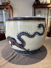 A pair of Chinese blue, white and copper-red 'dragon' fish bowls, Qianlong