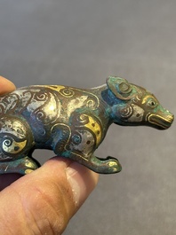 A rare Chinese gold and silver-inlaid bronze paperweight in the shape of a tapir '貘', Warring States period