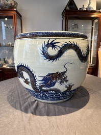 A pair of Chinese blue, white and copper-red 'dragon' fish bowls, Qianlong