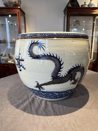 A pair of Chinese blue, white and copper-red 'dragon' fish bowls, Qianlong