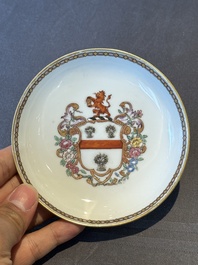 A pair of Chinese armorial famille rose cups and saucers with the arms of Tyndall for the English market and two monogrammed bowls, Qianlong