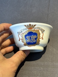 A pair of Chinese armorial famille rose cups and saucers with the arms of Tyndall for the English market and two monogrammed bowls, Qianlong