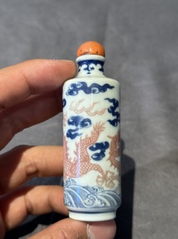 A Chinese blue, white and copper-red 'dragon' snuff bottle, 19th C.