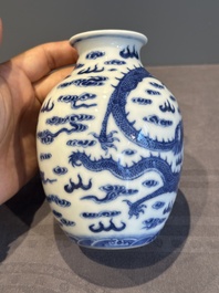 A Chinese blue and white 'dragon' vase, a famille rose 'millefleurs' vase and a teapot, Qianlong mark, 19/20th C.