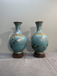 A pair of Chinese cloisonn&eacute; 'flowers and insects' vases on wooden stands, 18/19th C.