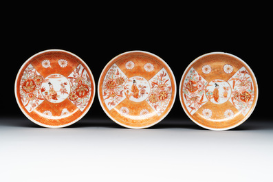 Six Chinese gilt-decorated iron-red cups and saucers with figural design, Yongzheng