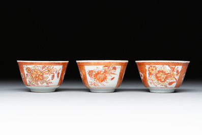 Six Chinese gilt-decorated iron-red cups and saucers with figural design, Yongzheng