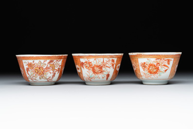 Six Chinese gilt-decorated iron-red cups and saucers with figural design, Yongzheng