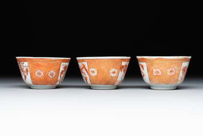 Six Chinese gilt-decorated iron-red cups and saucers with figural design, Yongzheng