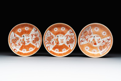 Six Chinese gilt-decorated iron-red cups and saucers with figural design, Yongzheng