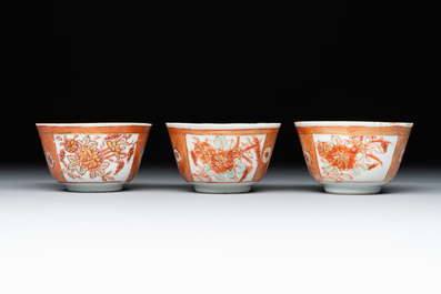 Six Chinese gilt-decorated iron-red cups and saucers with figural design, Yongzheng