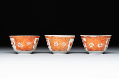 Six Chinese gilt-decorated iron-red cups and saucers with figural design, Yongzheng