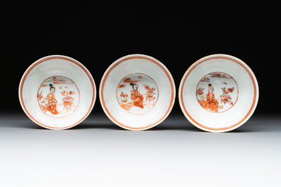 Six Chinese gilt-decorated iron-red cups and saucers with figural design, Yongzheng