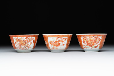 Six Chinese gilt-decorated iron-red cups and saucers with figural design, Yongzheng