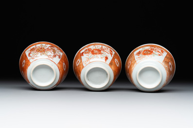 Six Chinese gilt-decorated iron-red cups and saucers with figural design, Yongzheng