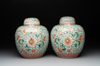 A pair of Chinese famille verte 'lotus scroll' jars and covers, 19th C.