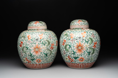 A pair of Chinese famille verte 'lotus scroll' jars and covers, 19th C.