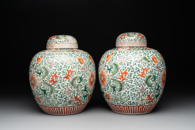 A pair of Chinese famille verte 'lotus scroll' jars and covers, 19th C.