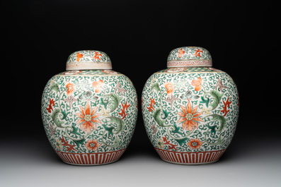 A pair of Chinese famille verte 'lotus scroll' jars and covers, 19th C.