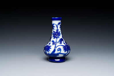 A Chinese blue-overlay white Beijing glass vase, a multi-colour brush pot and three bowls, 19th C.