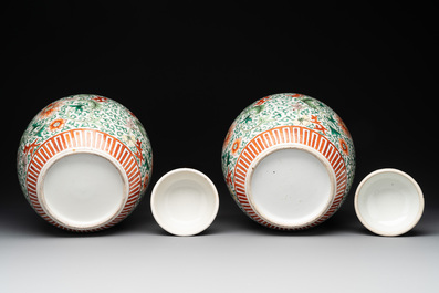 A pair of Chinese famille verte 'lotus scroll' jars and covers, 19th C.