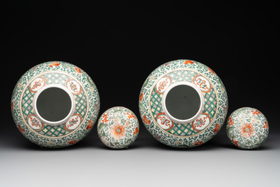 A pair of Chinese famille verte 'lotus scroll' jars and covers, 19th C.