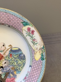 An extremely fine pair of Chinese famille rose 'ruby back' eggshell plates with a lady and playing boys, Yongzheng