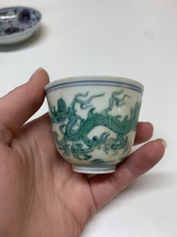 A Chinese gilt-decorated blue and white 'lotus scroll' square bowl, a saucer and a doucai 'dragon' cup, Daoguang mark and of the period