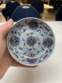 A Chinese gilt-decorated blue and white 'lotus scroll' square bowl, a saucer and a doucai 'dragon' cup, Daoguang mark and of the period