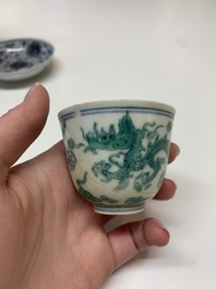 A Chinese gilt-decorated blue and white 'lotus scroll' square bowl, a saucer and a doucai 'dragon' cup, Daoguang mark and of the period