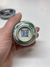 A Chinese gilt-decorated blue and white 'lotus scroll' square bowl, a saucer and a doucai 'dragon' cup, Daoguang mark and of the period