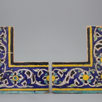 A pair of Isfahan cuerda seca corner tiles, 18/19th C.