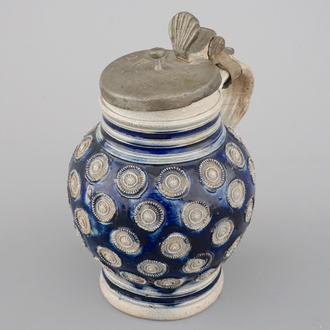 A globular Westerwald stoneware jug with appliques and pewter lid, dated 1689