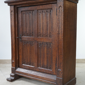 A gothic revival one door oak cabinet, 19th C.