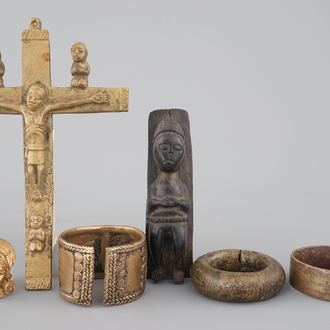 A selection of African bronze bracelets, a crucifix and carved wood figure, 19/20th C.