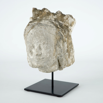 A carved stone head of a female saint, 14/15th C.