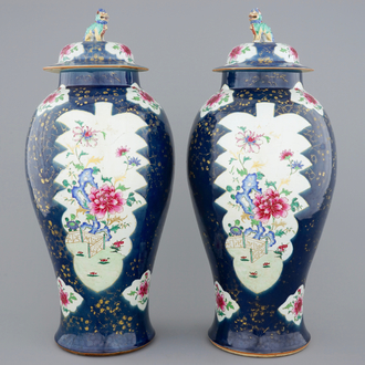 A tall pair of Chinese famille rose powder blue ground vases with covers, Qianlong, 18th C.