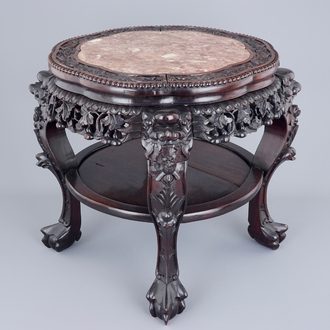 A large round Chinese carved wood stand with marble inset, 19th C.