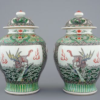 A pair of Chinese famille verte vases and covers with mythical beasts, 19/20th C.