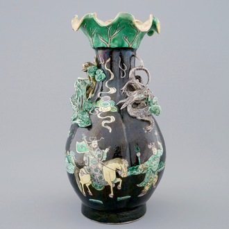 A Chinese famille noire lotus-shaped vase with applied dragons, 19th C.